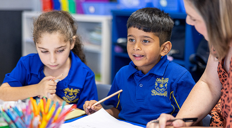 Students learning together with their teacher in the classroom at Our Lady of Mount Carmel Primary School Wentworthville