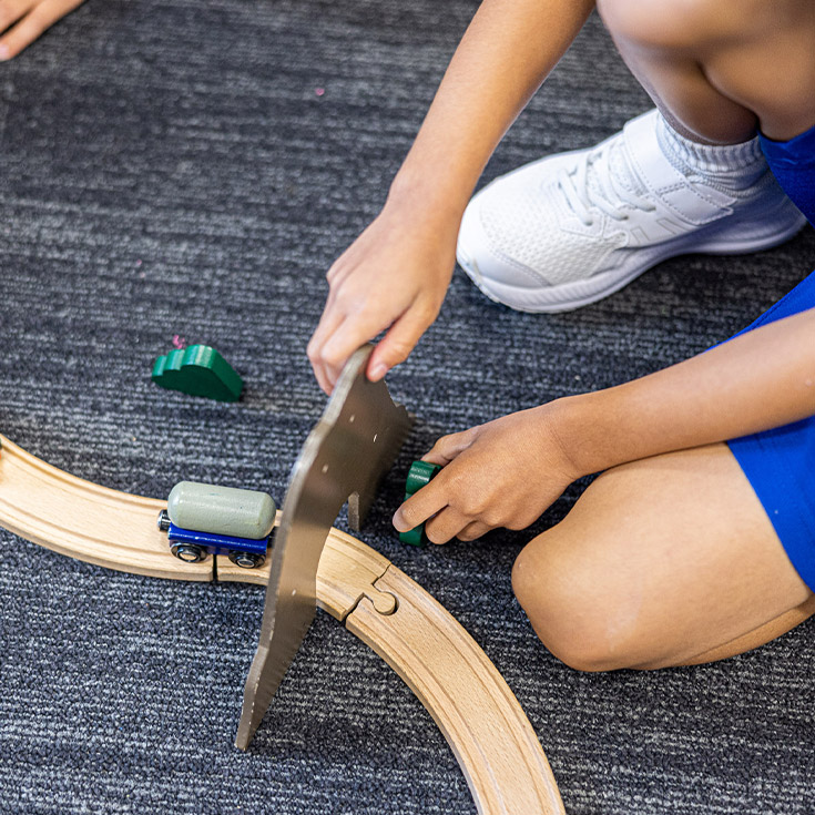 Students playing with toy trains at Our Lady of Mount Carmel Primary School Wentworthville