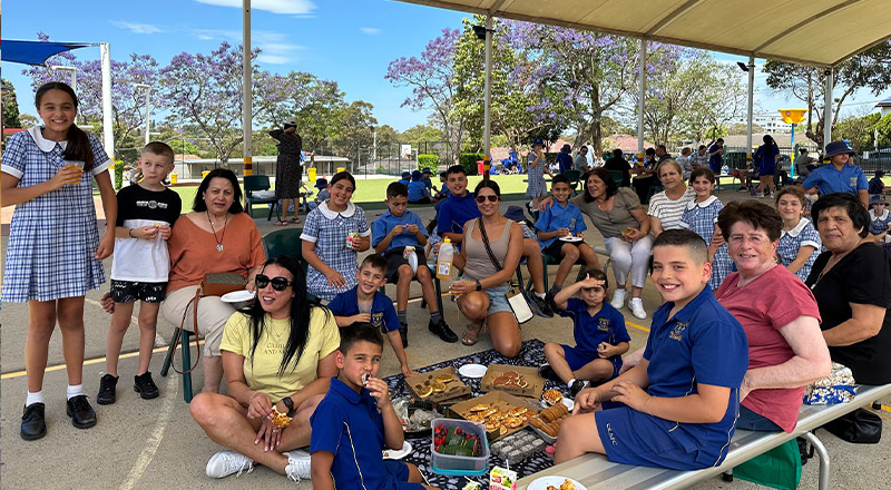 Parents and students on the playground at an event at Our Lady of Mount Carmel Primary School Wentworthville