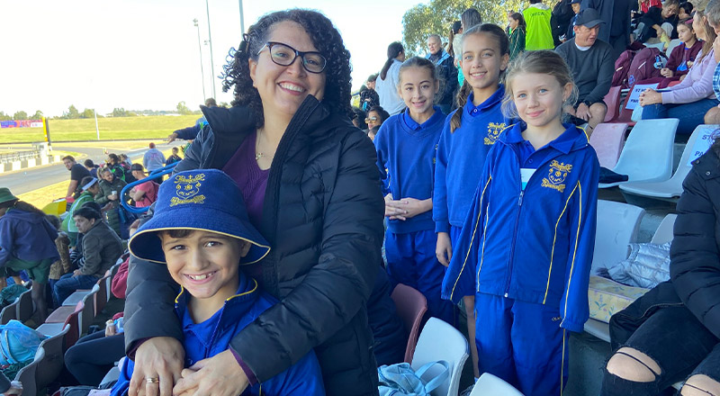 Student with his mother at the school sports carnival at Our Lady of Mount Carmel Primary School Wentworthville