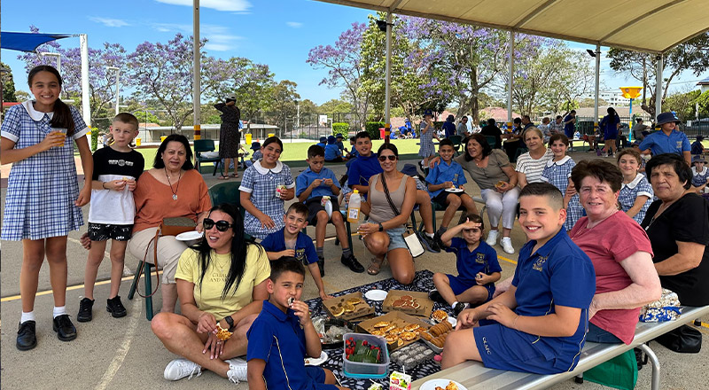 Students with their parents at a school celebration at Our Lady of Mount Carmel Primary School Wentworthville