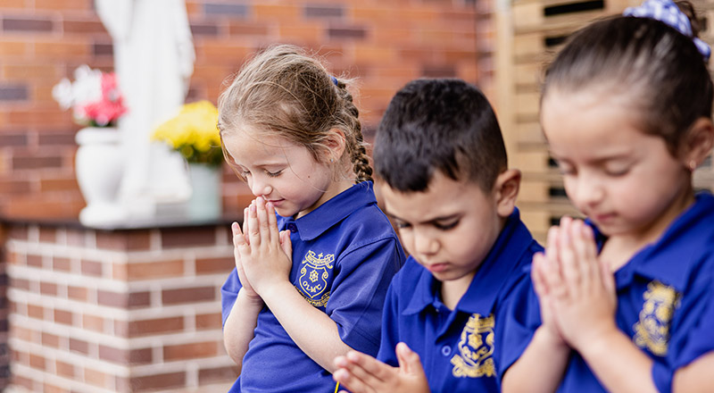 Students praying in the prayer garden at Our Lady of Mount Carmel Primary School Wentworthville