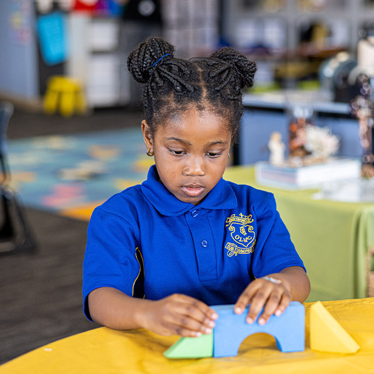 Student playing with blocks at Our Lady of Mount Carmel Primary School Wentworthville
