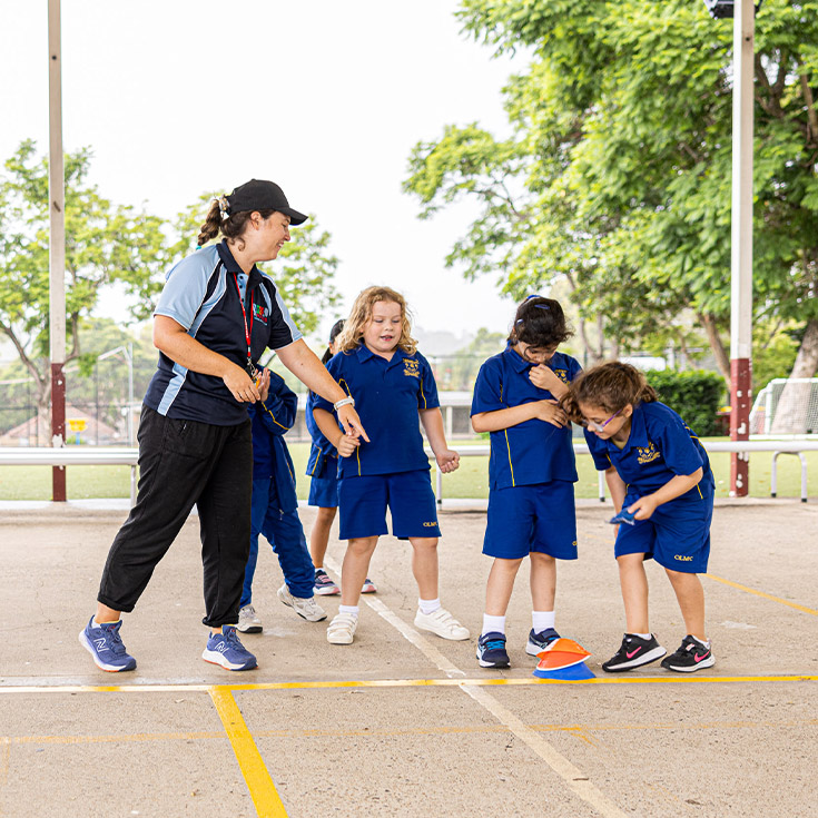 Teacher with students in the playground at Our Lady of Mount Carmel Primary School Wentworthville