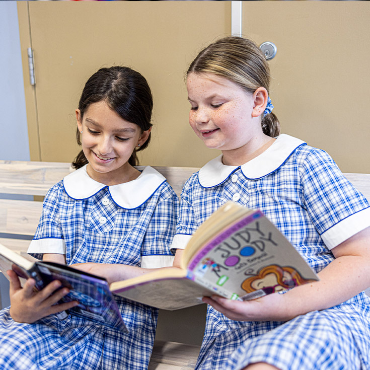 Students reading together in the library at Our Lady of Mount Carmel Primary School Wentworthville